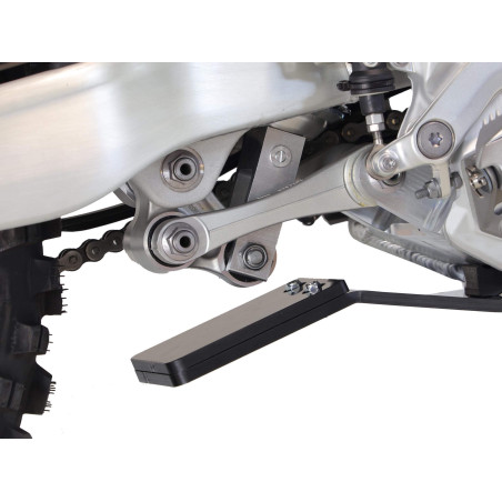 Close up view of the linkage guard of the black HDPE plastic skid plate for Triumph TF250-X and TF250-E
