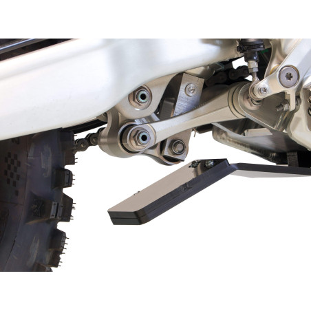 Close up view of the linkage guard of the black HDPE plastic skid plate for Triumph TF450-RC and TF450-E